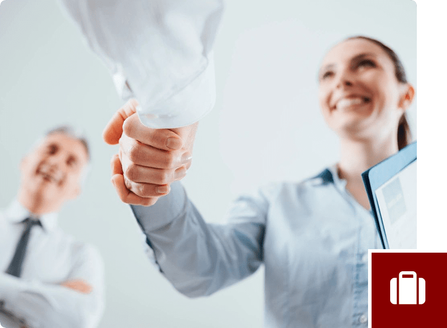 A woman shaking hands with another person.