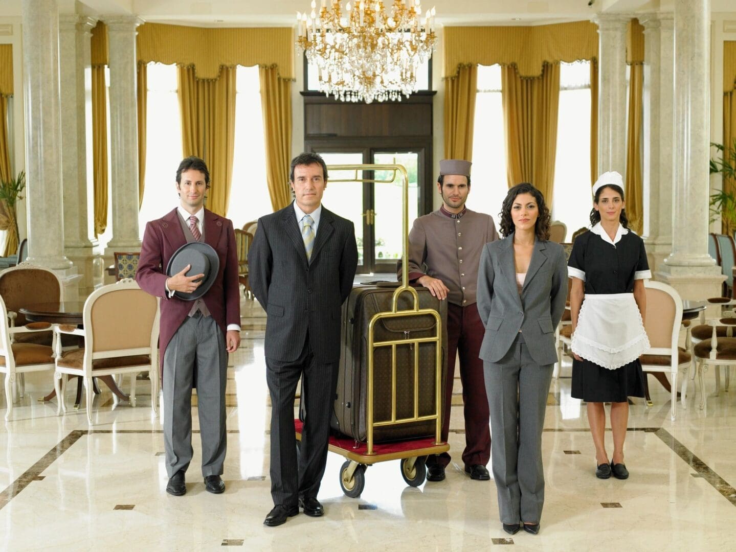 A group of people standing in front of a hotel room.